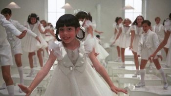 Movie still from “Pennies from Heaven” (1981), directed by Herbert Ross – A little girl in a white dress is posing for a picture; Medium shot, High angle