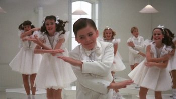 Movie still from “Pennies from Heaven” (1981), directed by Herbert Ross – A group of young children dressed in formal wear; Medium shot, Low angle