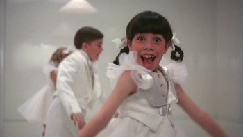Movie still from “Pennies from Heaven” (1981), directed by Herbert Ross – A little girl in a white dress is smiling for the camera; Close Up shot, Low angle