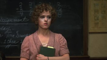 Movie still from “Pennies from Heaven” (1981), directed by Herbert Ross – A woman holding a book in front of a chalkboard; Close Up shot, High angle