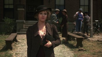 Movie still from “Pennies from Heaven” (1981), directed by Herbert Ross – A woman holding a wallet in a field; Medium shot, Over the shoulder angle