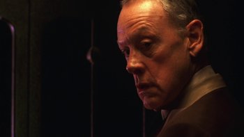 Movie still from “Pennies from Heaven” (1981), directed by Herbert Ross – An older man looking into the distance in a dimly - lit room; Close Up shot, Low angle