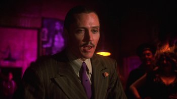 Movie still from “Pennies from Heaven” (1981), directed by Herbert Ross – A man in a striped suit and purple tie; Close Up shot, Low angle