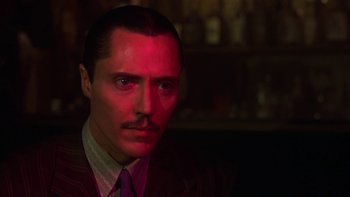 Movie still from “Pennies from Heaven” (1981), directed by Herbert Ross – A man in a suit and tie with a mustache; Close Up shot, Low angle