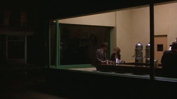 Movie still from “Pennies from Heaven” (1981), directed by Herbert Ross – A man and a woman are sitting at a table; Wide shot, Over the shoulder angle