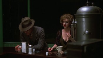 Movie still from “Pennies from Heaven” (1981), directed by Herbert Ross – A man and a woman sitting at a table; Medium shot, Over the shoulder angle