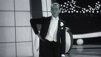 Movie still from “Pennies from Heaven” (1981), directed by Herbert Ross – A black and white photo of a man in a tuxedo; Medium shot, Low angle