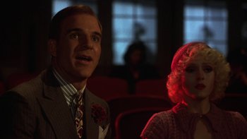 Movie still from “Pennies from Heaven” (1981), directed by Herbert Ross – A man and a woman are sitting in a movie theater; Close Up shot, Low angle