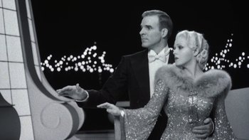 Movie still from “Pennies from Heaven” (1981), directed by Herbert Ross – A man and a woman dressed in formal attire; Medium shot, Low angle