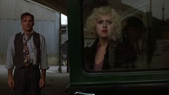 Movie still from “Pennies from Heaven” (1981), directed by Herbert Ross – A woman with blonde curly hair looking out a window; Close Up shot, Over the shoulder angle