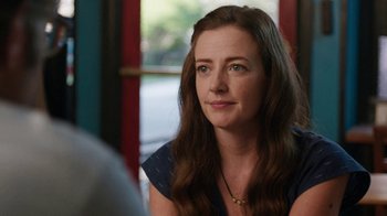 Movie still from “People Places Things” (2015), directed by Jim Strouse – A person sitting at a table; Close Up shot, Over the shoulder angle