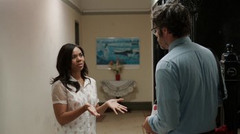 Movie still from “People Places Things” (2015), directed by Jim Strouse – A woman and a man are talking in a room; Medium shot, Over the shoulder angle