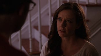 Movie still from “People Places Things” (2015), directed by Jim Strouse – A person standing on a staircase; Close Up shot, Over the shoulder angle