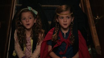 Movie still from “People Places Things” (2015), directed by Jim Strouse – Two little girls dressed up like superheroes; Close Up shot, High angle