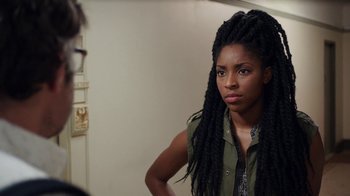 Movie still from “People Places Things” (2015), directed by Jim Strouse – A woman with long dreadlocks standing in front of a mirror; Close Up shot, Over the shoulder angle