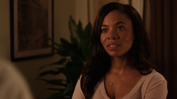 Movie still from “People Places Things” (2015), directed by Jim Strouse – A woman with long black hair wearing a white shirt; Close Up shot, Over the shoulder angle