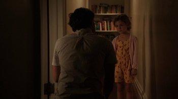 Movie still from “People Places Things” (2015), directed by Jim Strouse – A man and a little girl standing in front of a book shelf; Medium shot, Over the shoulder angle