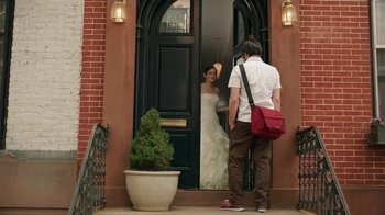 Movie still from “People Places Things” (2015), directed by Jim Strouse – A man and a woman standing in front of a door; Wide shot, Over the shoulder angle