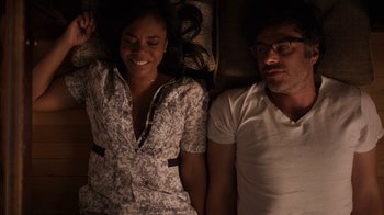 Movie still from “People Places Things” (2015), directed by Jim Strouse – A man and a woman laying next to each other on a bed; Medium shot, Overhead angle