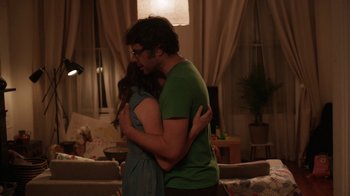 Movie still from “People Places Things” (2015), directed by Jim Strouse – A man and a woman hugging in a living room; Medium shot, Over the shoulder angle