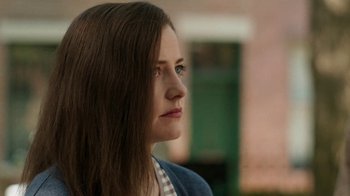 Movie still from “People Places Things” (2015), directed by Jim Strouse – A person with long brown hair; Close Up shot, Over the shoulder angle