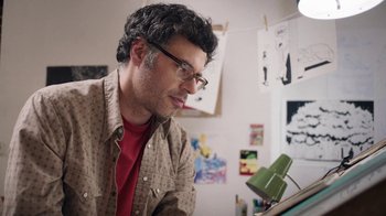 Movie still from “People Places Things” (2015), directed by Jim Strouse – A man looking at a tablet in a room; Close Up shot, Low angle
