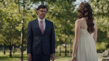 Movie still from “People Places Things” (2015), directed by Jim Strouse – A man and a woman standing in the grass; Medium shot, Over the shoulder angle