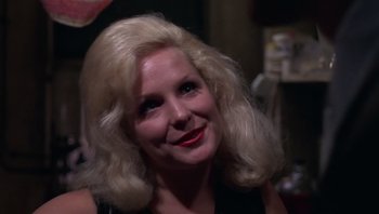 Movie still from “Performance” (1970), directed by Donald Cammell – A person with blonde hair; Close Up shot, Over the shoulder angle