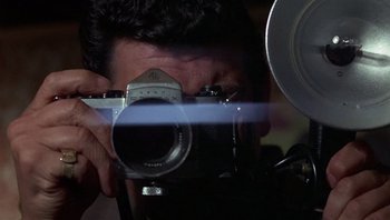 Movie still from “Performance” (1970), directed by Donald Cammell – A man taking a picture with an old fashioned camera; Extreme Close Up shot, Low angle