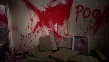 Movie still from “Performance” (1970), directed by Donald Cammell – A living room with a couch and a painting on the wall; Wide shot, High angle