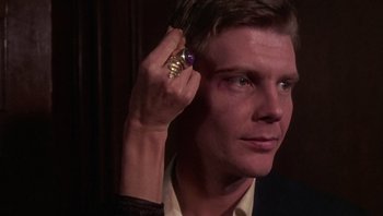 Movie still from “Performance” (1970), directed by Donald Cammell – A person with a ring on his finger; Close Up shot, Over the shoulder angle