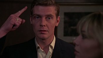 Movie still from “Performance” (1970), directed by Donald Cammell – A man and a woman in a dark room; Close Up shot, Over the shoulder angle