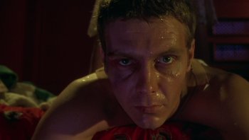 Movie still from “Performance” (1970), directed by Donald Cammell – A person with blood on his face; Close Up shot, Low angle
