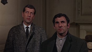 Movie still from “Performance” (1970), directed by Donald Cammell – Two men standing next to each other wearing suits and ties; Medium shot, Low angle