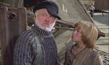 Movie still from “Pete's Dragon” (1977), directed by Don Chaffey – An older man and a young boy standing next to a fishing net; Medium shot, Low angle