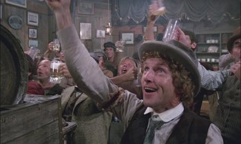 Movie still from “Pete's Dragon” (1977), directed by Don Chaffey – A group of people are drinking beer in a bar; Medium shot, Low angle