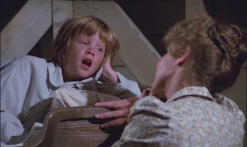 Movie still from “Pete's Dragon” (1977), directed by Don Chaffey – A woman and a child in a room; Close Up shot, Over the shoulder angle