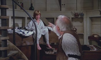 Movie still from “Pete's Dragon” (1977), directed by Don Chaffey – An older man pointing at a young girl; Medium shot, High angle