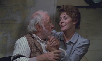Movie still from “Pete's Dragon” (1977), directed by Don Chaffey – An older man and a younger woman holding each other; Close Up shot, Over the shoulder angle