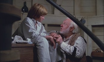 Movie still from “Pete's Dragon” (1977), directed by Don Chaffey – An older man and a young boy sitting next to each other; Medium shot, High angle