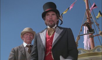 Movie still from “Pete's Dragon” (1977), directed by Don Chaffey – A man in a top hat and a man in a suit and tie; Medium shot, Low angle