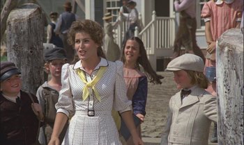 Movie still from “Pete's Dragon” (1977), directed by Don Chaffey – A group of people walking down a sidewalk; Medium shot, Low angle