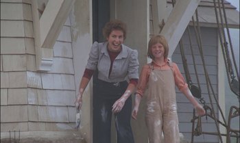 Movie still from “Pete's Dragon” (1977), directed by Don Chaffey – A woman and a girl are holding paint brushes; Medium shot, Low angle