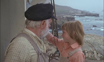 Movie still from “Pete's Dragon” (1977), directed by Don Chaffey – An old man and a young boy are on a swing; Medium shot, Over the shoulder angle