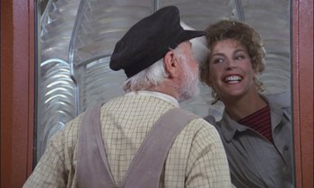 Movie still from “Pete's Dragon” (1977), directed by Don Chaffey – An older man and a young woman are smiling; Close Up shot, Over the shoulder angle