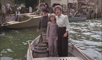 Movie still from “Pete's Dragon” (1977), directed by Don Chaffey – A man and a woman and a boy in a boat; Medium shot, High angle