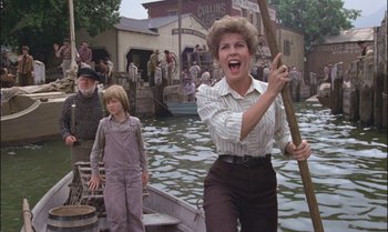 Movie still from “Pete's Dragon” (1977), directed by Don Chaffey – A woman and a boy are in a row boat; Medium shot, Over the shoulder angle