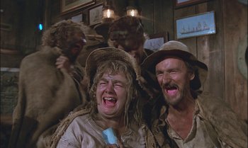 Movie still from “Pete's Dragon” (1977), directed by Don Chaffey – A group of people in a room with a microphone; Medium shot, Low angle