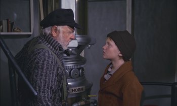 Movie still from “Pete's Dragon” (1977), directed by Don Chaffey – An older man and a young boy standing next to each other; Medium shot, Over the shoulder angle
