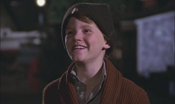 Movie still from “Pete's Dragon” (1977), directed by Don Chaffey – A young boy wearing a sweater and a hat; Close Up shot, Low angle